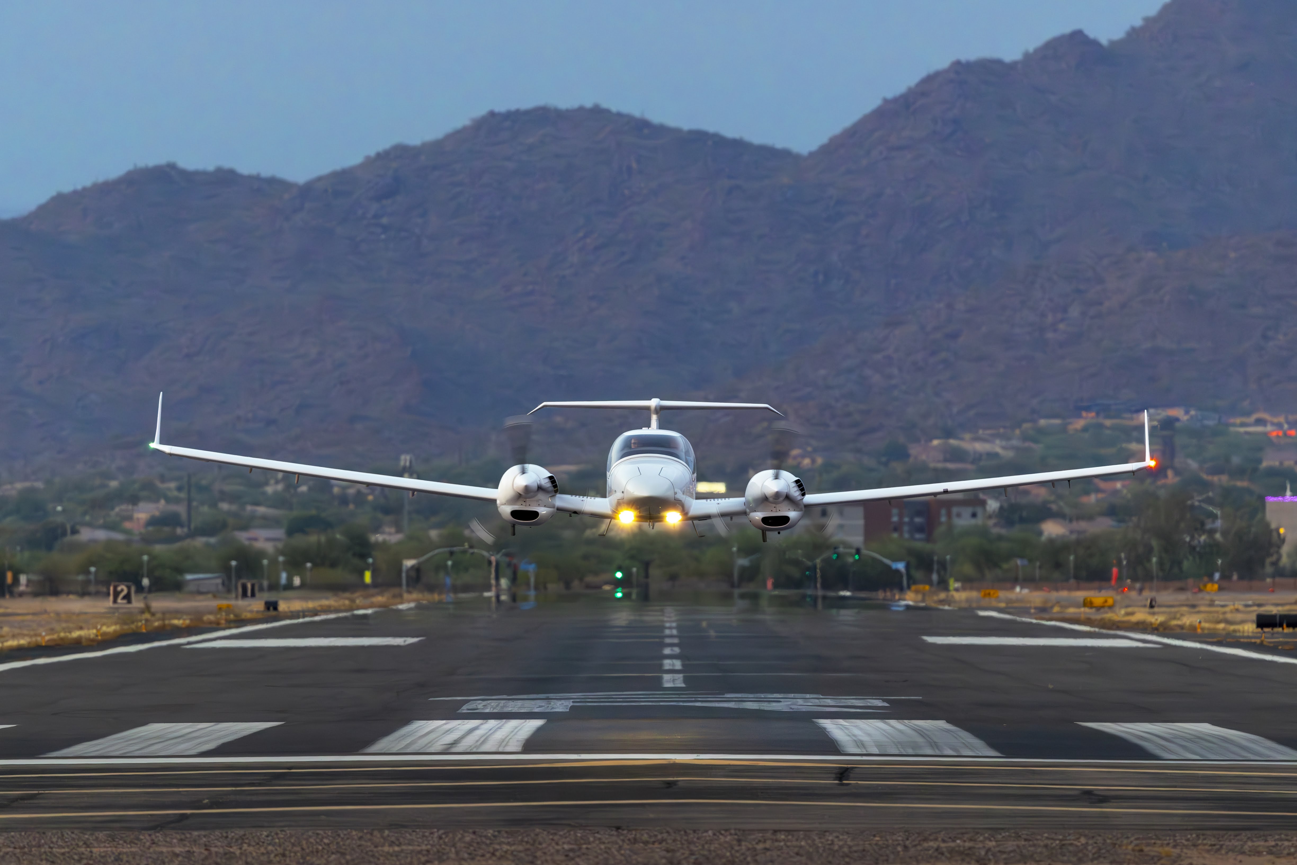 Diamond DA42 head-on approach with landing lights