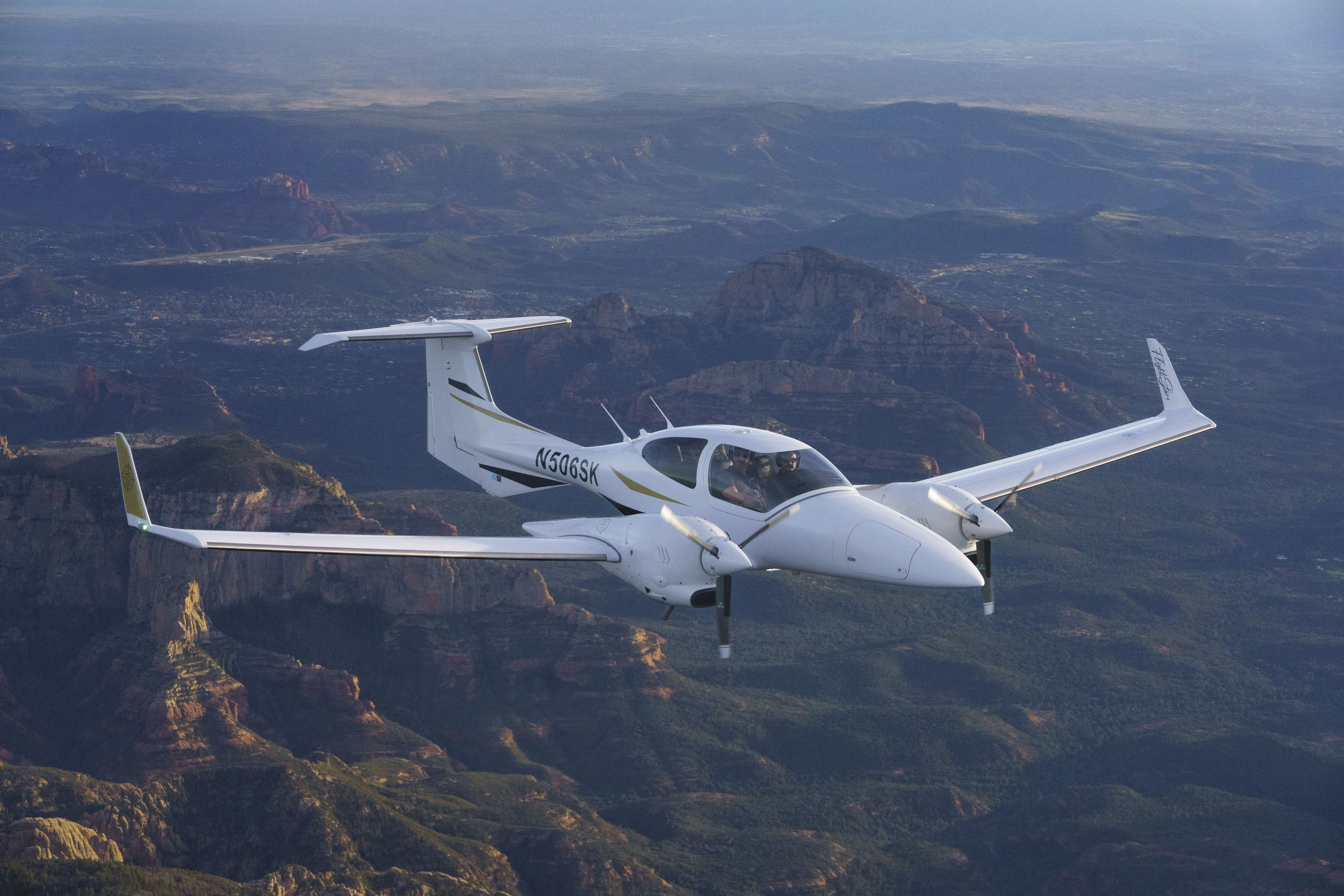 Diamond DA42 banking over canyon